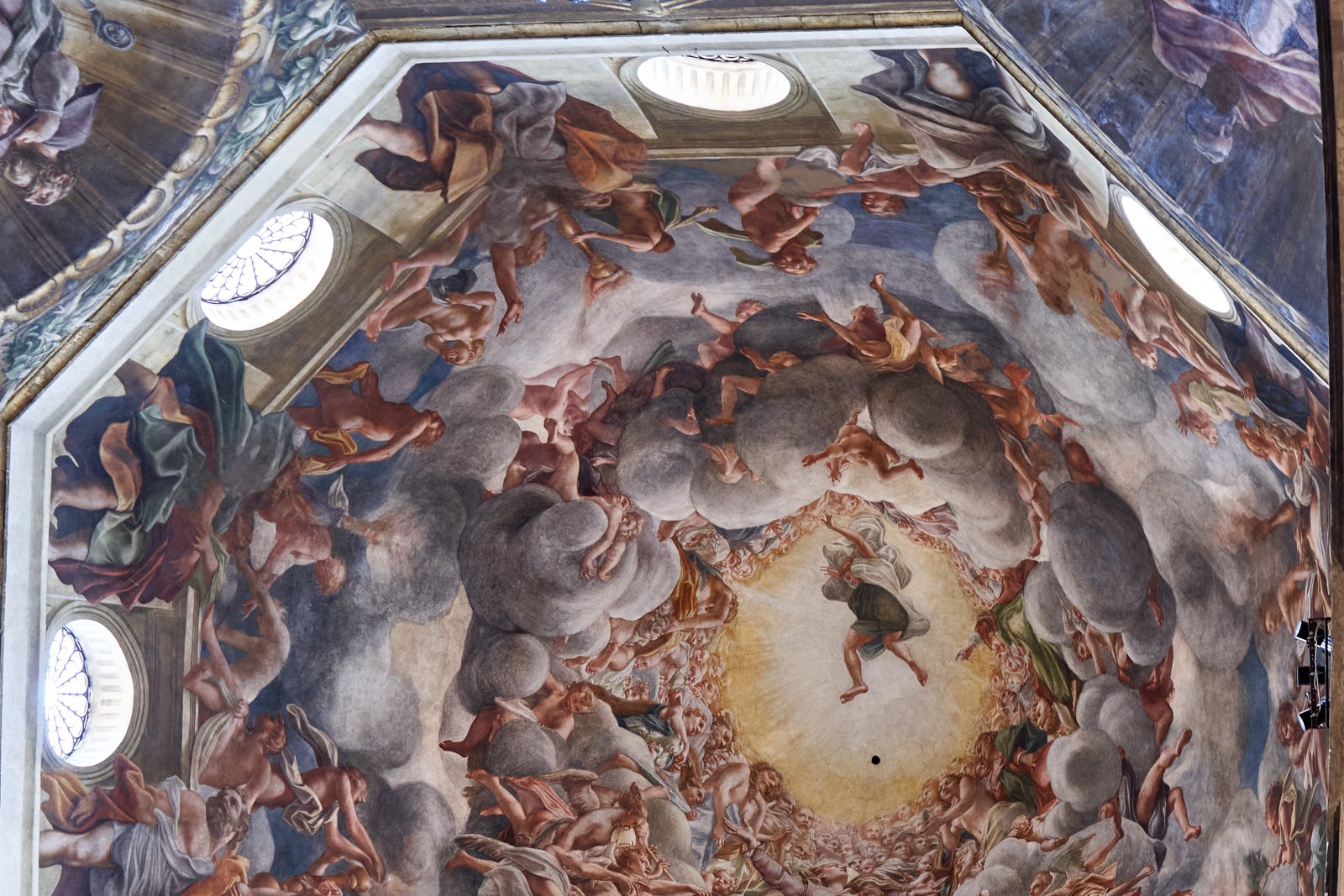 The dome fresco of the Assumption of the Virgin by Correggio in Parma Cathedral, showing a swirling composition of clouds and ascending figures viewed from directly below.